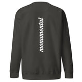 the back side of a black monumental clothing sweatshirt with a white logo